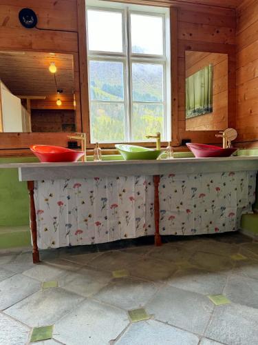 a bathroom with three sinks in a room at Meiriet1936 in Fjarland