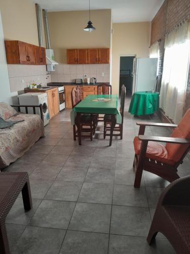 a kitchen with a green table and chairs in a room at Graciela in Villa Las Rosas