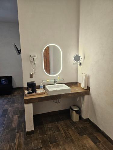 a bathroom with a sink and a mirror at Hotel del Carbón in Villa del Carbón