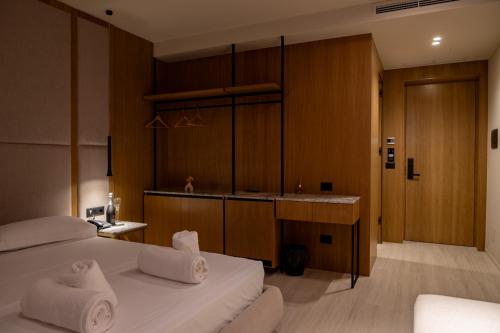 a hotel room with a bed and a sink at South Inn Marina Hotel in Vlorë
