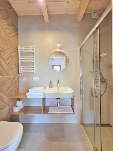 a bathroom with a sink and a shower at Morze Las in Ustka