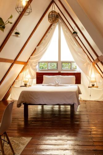 a bedroom with a white bed in a tent at Boquete Firefly Inn in Boquete