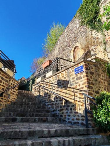 a set of stairs with a blue sign on it at Cœur de Toucy in Toucy
