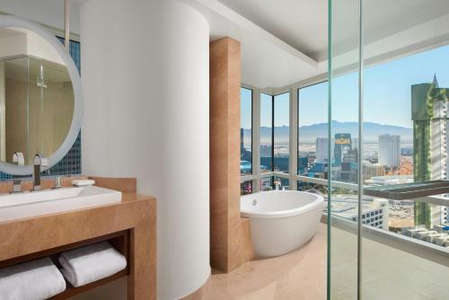 a bathroom with a tub and a view of the city at ARIA Resort & Casino in Las Vegas