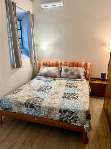 a bed in a small room with a window at Casale di Torvaianica in Campo Iemini