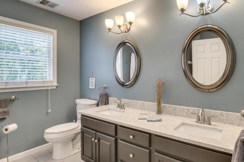 a bathroom with a sink and a toilet and mirrors at Heated Pool, 6 Acres: Beacon Area Vacation Rental in Lagrangeville