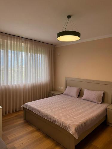 a bedroom with a bed with two pink pillows at Rrode Apartment Tale Beach in (( Shën Ded Gjoni ))