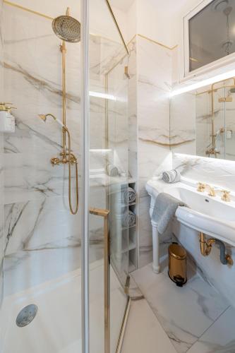 a white bathroom with a shower and a sink at Domaine de La Bourse in Vérigny