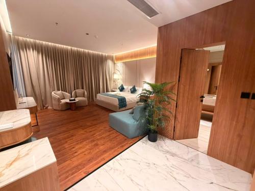 a bedroom with a bed and a couch in a room at KH La Maison in Abha