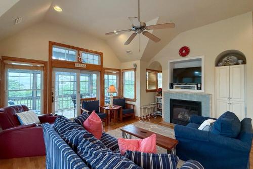 a living room with blue couches and a fireplace at 2433 - Bella Bay in Duck