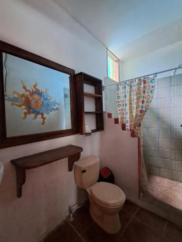 a bathroom with a toilet and a shower at Lazy Crab Hostel in Balgue
