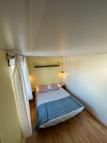 a bedroom with a bed in a small room at Beach Break Bungalows Playa El Palmar in Cádiz