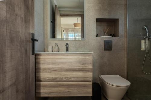 a bathroom with a sink and a toilet at AnaRose Zante Villa-by Sakis and Sam in Planos
