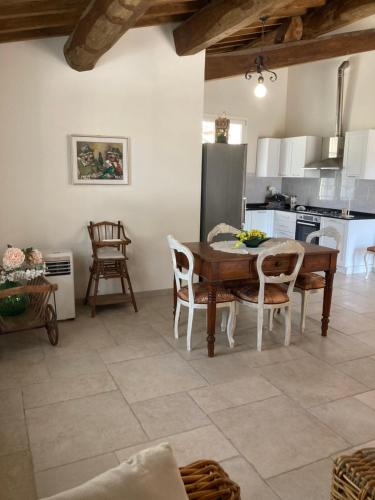 a kitchen with a table and chairs in a room at Villa sport relax in Colle di Val d'Elsa
