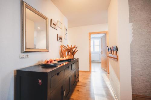 a kitchen with a black dresser with fruit on it at Appartement Urlaub Exklusiv in Lackenhof