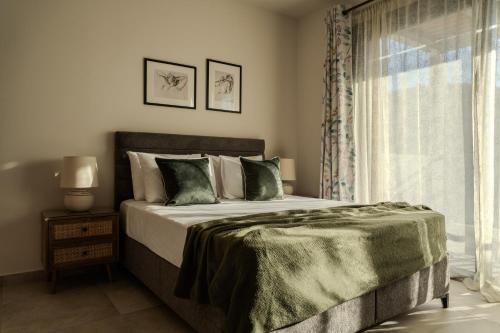 a bedroom with a large bed and a window at AnaRose Zante Villa-by Sakis and Sam in Planos