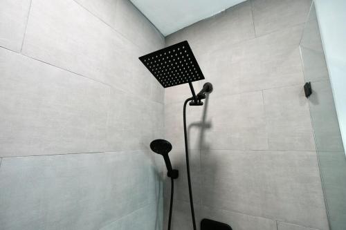 a shower with a shower head in a bathroom at Private Pool Near Guitar Hotel & Beach in Hollywood