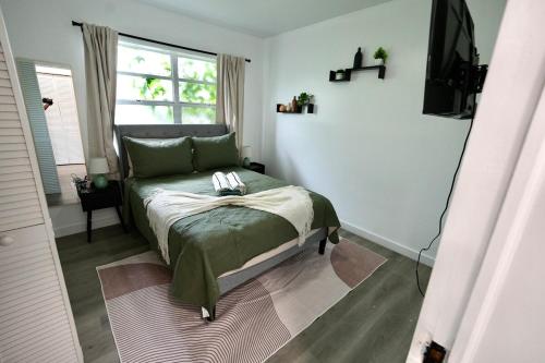 a bedroom with a bed and a television in it at Private Pool Near Guitar Hotel & Beach in Hollywood