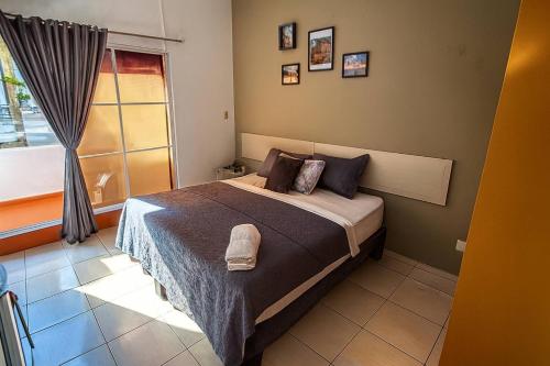a bedroom with a bed and a window at A Night at Zona colonial in Santo Domingo