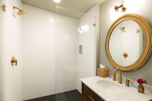 a bathroom with a sink and a mirror at The Nicholas Veranda King Suite - Steps to King in Charleston