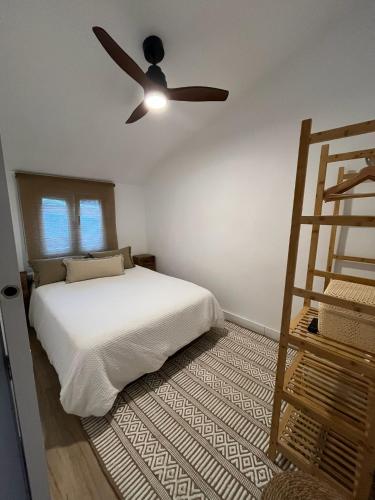 a bedroom with a bed and a ceiling fan at El Palomar in El Arenal