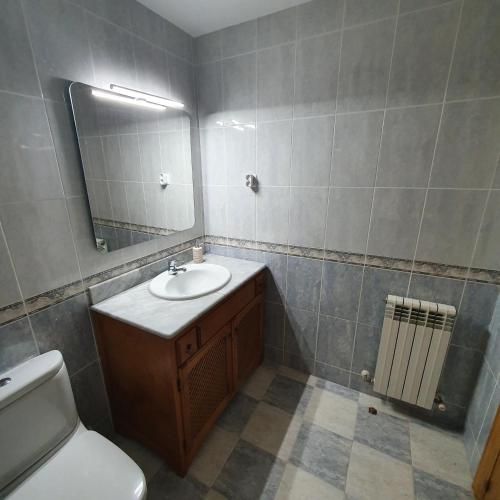 a bathroom with a sink and a mirror and a toilet at El Burgo Eclipse Retreat in El Burgo de Osma