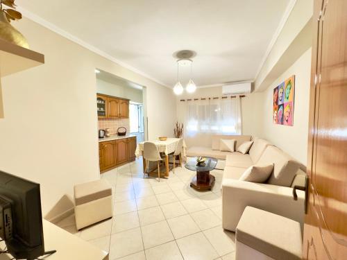 a living room with a couch and a table at Luna Apartment in Durrës