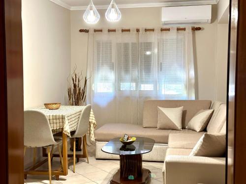 a living room with a couch and a table at Luna Apartment in Durrës
