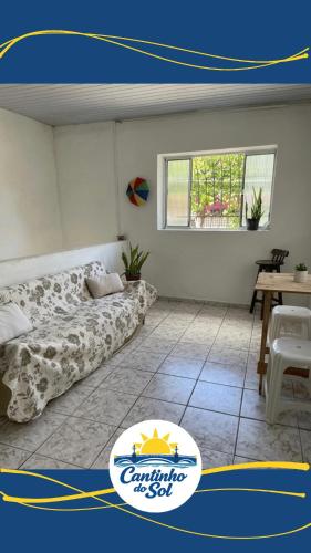 a room with a bed and a table and a window at Cantinho do Sol in Recife