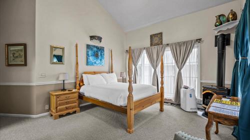 a bedroom with a wooden bed and a window at Black Bear Manor in Ouray