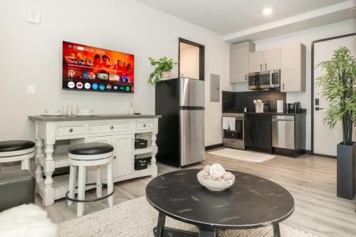 a large kitchen with a table and a refrigerator at NEW Ski-In Ski-Out Romantic Studio for Two in Winter Park