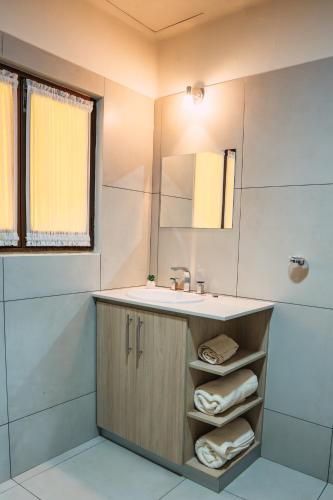 a bathroom with a sink and a mirror at Hotel Boutique La Casona in Tarija
