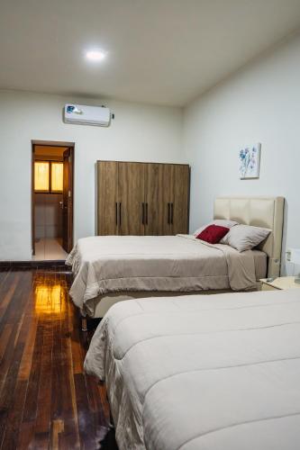a room with three beds in a room at Hotel Boutique La Casona in Tarija