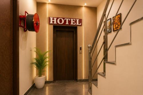 a hotel hallway with a hotel sign and a plant at Hotel Devine Opp Jubilee Walk Mall & Near Gurdwara Sohana in Sohāna