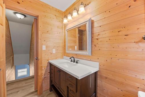 a bathroom with a sink and a mirror at Sunshine Days OBX in Nags Head