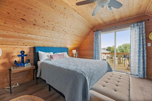 a bedroom with a bed and a large window at Sunshine Days OBX in Nags Head