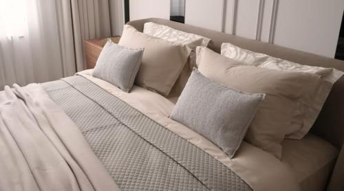 a bed with white pillows on top of it at La Dolce Sosta in Venice