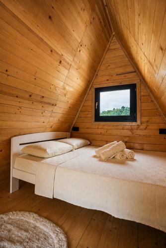 a bedroom with two beds in a wooden cabin at Rzav A - Frames in Arilje