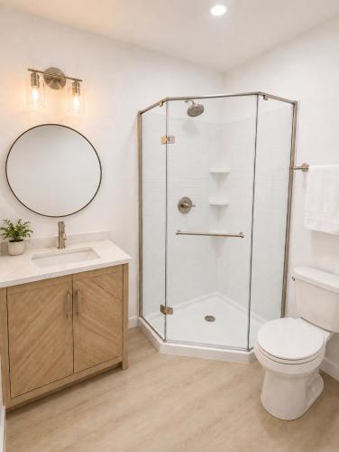 a bathroom with a shower and a toilet and a sink at The Linda Grande Hotel in Ocean City