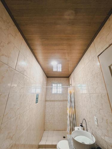 a bathroom with a toilet and a sink at Cabañas de Asgard in Nueva Gorgona