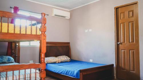 a bedroom with a bunk bed with a blue bedsheet at Cabañas de Asgard in Nueva Gorgona
