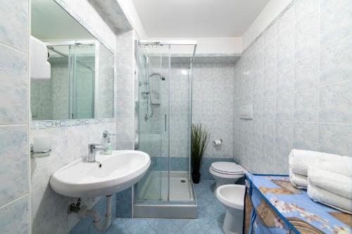 a bathroom with a sink and a shower and a toilet at Appartamento Centrale in Ischia Town