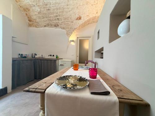 a table in a kitchen with a plate on it at Casa Maresca in Ostuni