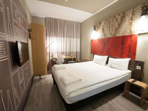 a hotel room with a bed and a tv at Ibis Konya in Konya