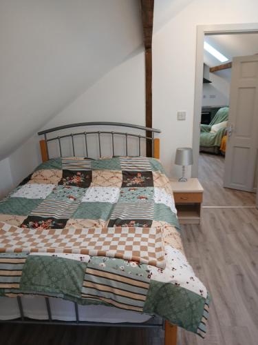 a bed with a quilt on it in a bedroom at Roshinehill apartment in Shanbally