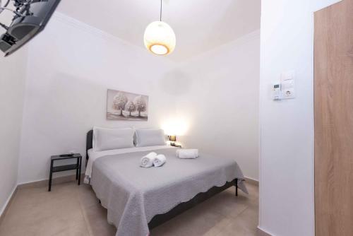 a bedroom with a bed with two towels on it at Angie's House Volos in Volos