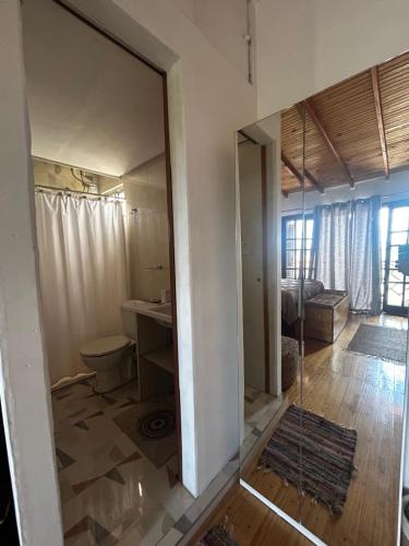 a bathroom with a mirror in a room at Hospedaje Rivera Chico in Rivera