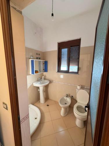 a bathroom with a toilet and a sink at General's Beach House in Kavajë