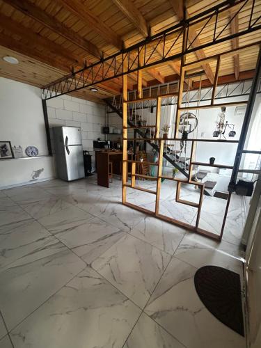 a large room with a kitchen and a refrigerator at Hospedaje Rivera Chico in Rivera