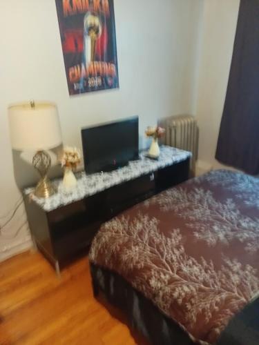 a bedroom with a bed and a desk with a television at Anderson home services in Woodlawn